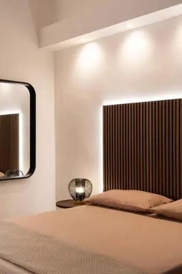 a bedroom with a bed and a mirror at Cavalieri Suites Roma in Rome