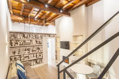 a room with a staircase with a wall of sculptures at Ciambella Atmosphere by Rental in Rome in Rome