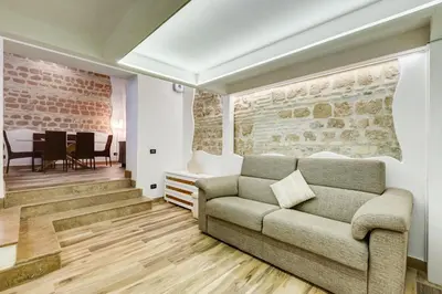 a living room with a couch and a dining room at Dream Home in Rome