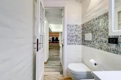a bathroom with a toilet and a hallway at Dream Home in Rome