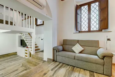 a living room with a couch and stairs at Dream Home in Rome
