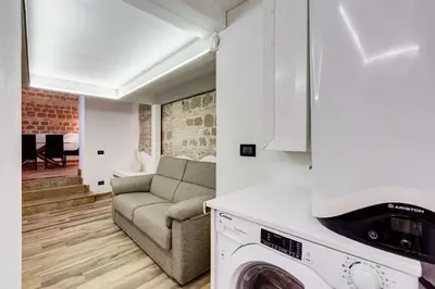 a living room with a couch and a washer and dryer at Dream Home in Rome