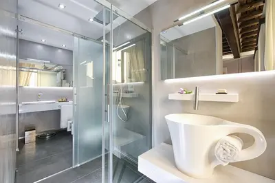 a bathroom with a toilet and a glass shower at Domus Libera in Rome