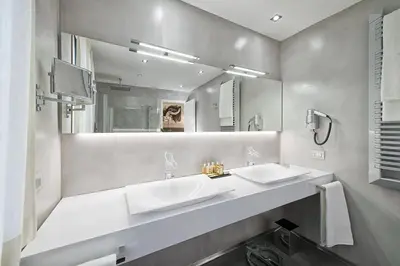 a bathroom with two sinks and a large mirror at Domus Libera in Rome
