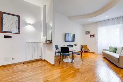 a kitchen with white cabinets and a sink at Gaia's Place! in Rome
