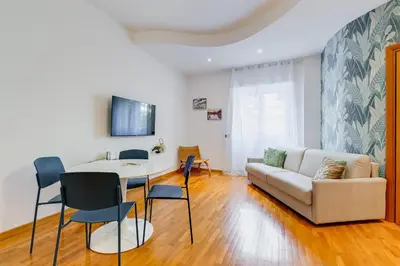 a living room with a white couch and a table at Gaia's Place! in Rome