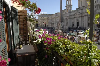 a balcony with flowers on a city street at Appartamento Benincampi in Rome