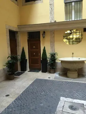 a building with a fountain in front of a building at Appartamento Benincampi in Rome