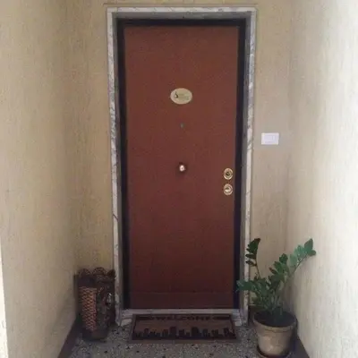 a brown door in a hallway with a plant at Sweet Dreams in St Peter B&b in Rome