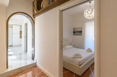 a bedroom with a bed and a mirror at Appia Antica Park - Apartment with Terrace in Rome