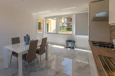 a kitchen with a table and chairs in a kitchen at Appia Antica Park - Apartment with Terrace in Rome