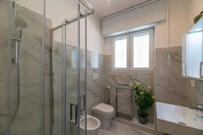 a bathroom with a shower and a toilet and a sink at Appia Antica Park - Apartment with Terrace in Rome