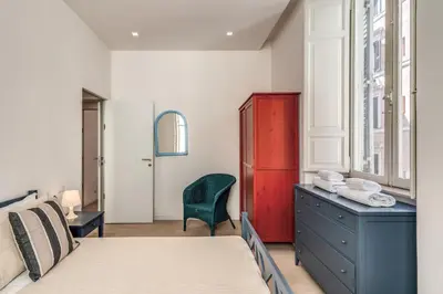 a bedroom with a bed and a desk and a chair at Fresh House Fori Imperiali in Rome
