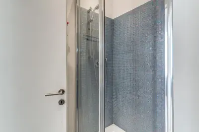 a shower with a glass door in a bathroom at Fresh House Fori Imperiali in Rome