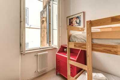 a bedroom with a bunk bed and a window at Fresh House Fori Imperiali in Rome