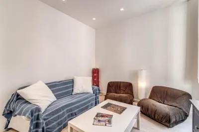 a living room with a couch and two chairs at Fresh House Fori Imperiali in Rome