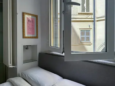 a room with a window and a bed and a mirror at Domus Alexander, Terrace Downtown Apartment in Rome