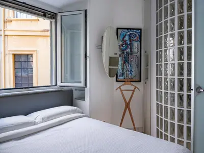 a bedroom with a bed and a window at Domus Alexander, Terrace Downtown Apartment in Rome