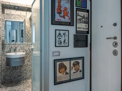 a bathroom with pictures on the wall and a sink at Domus Alexander, Terrace Downtown Apartment in Rome