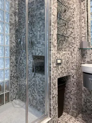 a shower with a glass door in a bathroom at Domus Alexander, Terrace Downtown Apartment in Rome