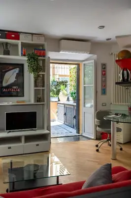 a living room with a couch and a tv at Domus Alexander, Terrace Downtown Apartment in Rome