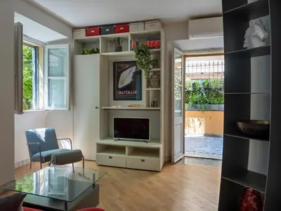 a living room with a tv and a glass table at Domus Alexander, Terrace Downtown Apartment in Rome