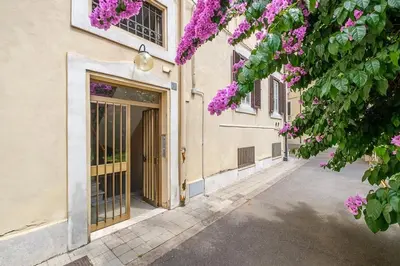 a building with a door with purple flowers at ht la spezia bilo in Rome