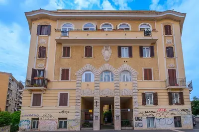 a large yellow building with graffiti on it at ht la spezia bilo in Rome