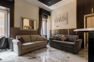 a living room with two couches and a mirror at Angie's Dream Home - Spanish Steps Rome in Rome