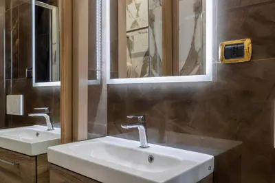 a bathroom with two sinks and two mirrors at Angie's Dream Home - Spanish Steps Rome in Rome