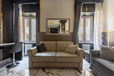 a living room with a couch and a mirror at Angie's Dream Home - Spanish Steps Rome in Rome