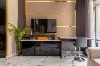 a living room with a tv and a desk at Angie's Dream Home - Spanish Steps Rome in Rome