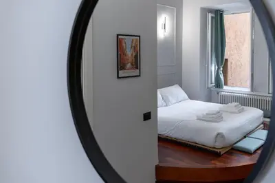 a mirror reflection of a bed in a bedroom at Vicomoro House Trastevere in Rome