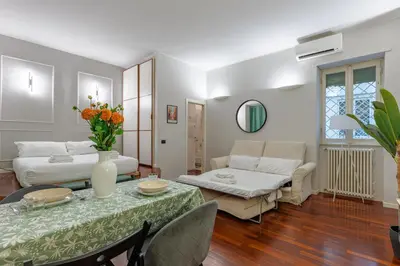 a living room with a table and a couch at Vicomoro House Trastevere in Rome
