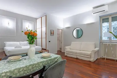 a living room with a table and a couch at Vicomoro House Trastevere in Rome