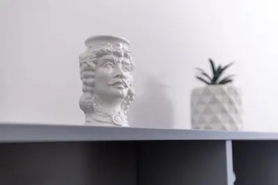 a statue sitting on top of a shelf with a pineapple at Vicomoro House Trastevere in Rome