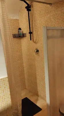a shower with a shower curtain in a bathroom at crescenziovaticanflat in Rome