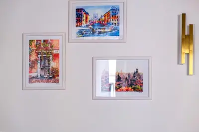 four framed pictures on a white wall at Elegantis Trevi Suite Apartment - Just 50m from Trevi Fountain in Rome