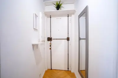 an open door in a white room with a plant on the ceiling at Elegantis Trevi Suite Apartment - Just 50m from Trevi Fountain in Rome