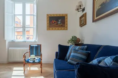 a living room with a blue couch and a table at iFlat Campo de' Fiori Brand New & Bright apt in Rome