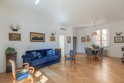 a living room with a blue couch and a table at iFlat Campo de' Fiori Brand New & Bright apt in Rome
