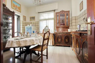 a kitchen with a table and chairs in a room at Luxury Trastevere Terraces in Rome