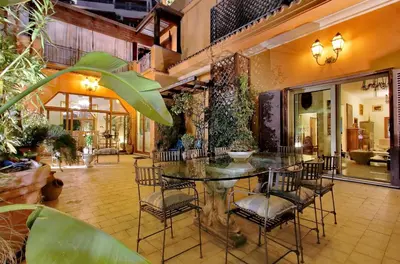 a dining room with a glass table and chairs at Luxury Trastevere Terraces in Rome