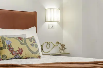 a bedroom with a bed with a pillow and a lamp at Pantheon Apartments - Piccola Roma in Rome