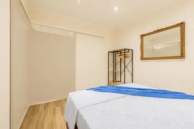 a white bedroom with a bed and a mirror at Pantheon Apartments - Piccola Roma in Rome