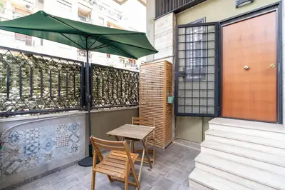 a table and two chairs and an umbrella on a patio at A 10 min da San Giovanni Casa Indipendente in Rome