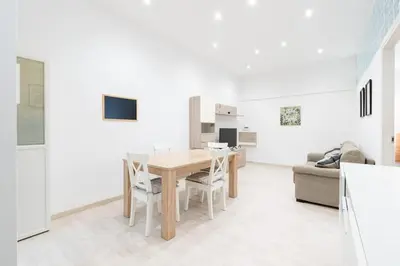 a kitchen and dining room with a table and chairs at A 10 min da San Giovanni Casa Indipendente in Rome