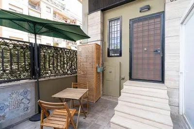 a patio with a table and chairs and a door at A 10 min da San Giovanni Casa Indipendente in Rome