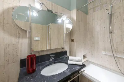 a bathroom with a sink and a mirror at Bernini al Borgo in Rome