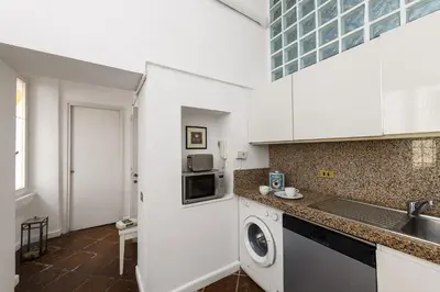 a kitchen with a washer and dryer in a room at Bernini al Borgo in Rome